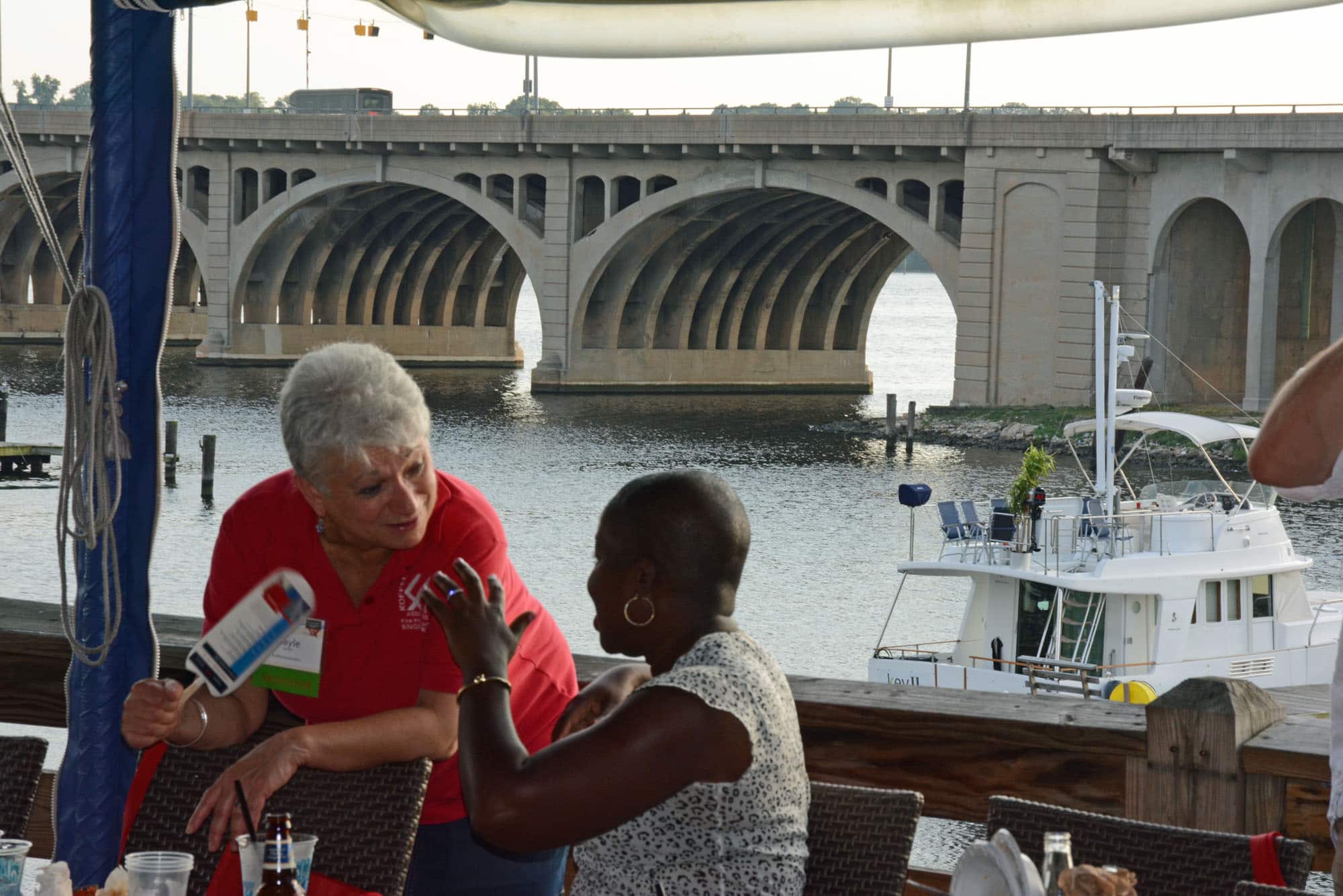 Guests mixed and mingled, with a waterfront view.