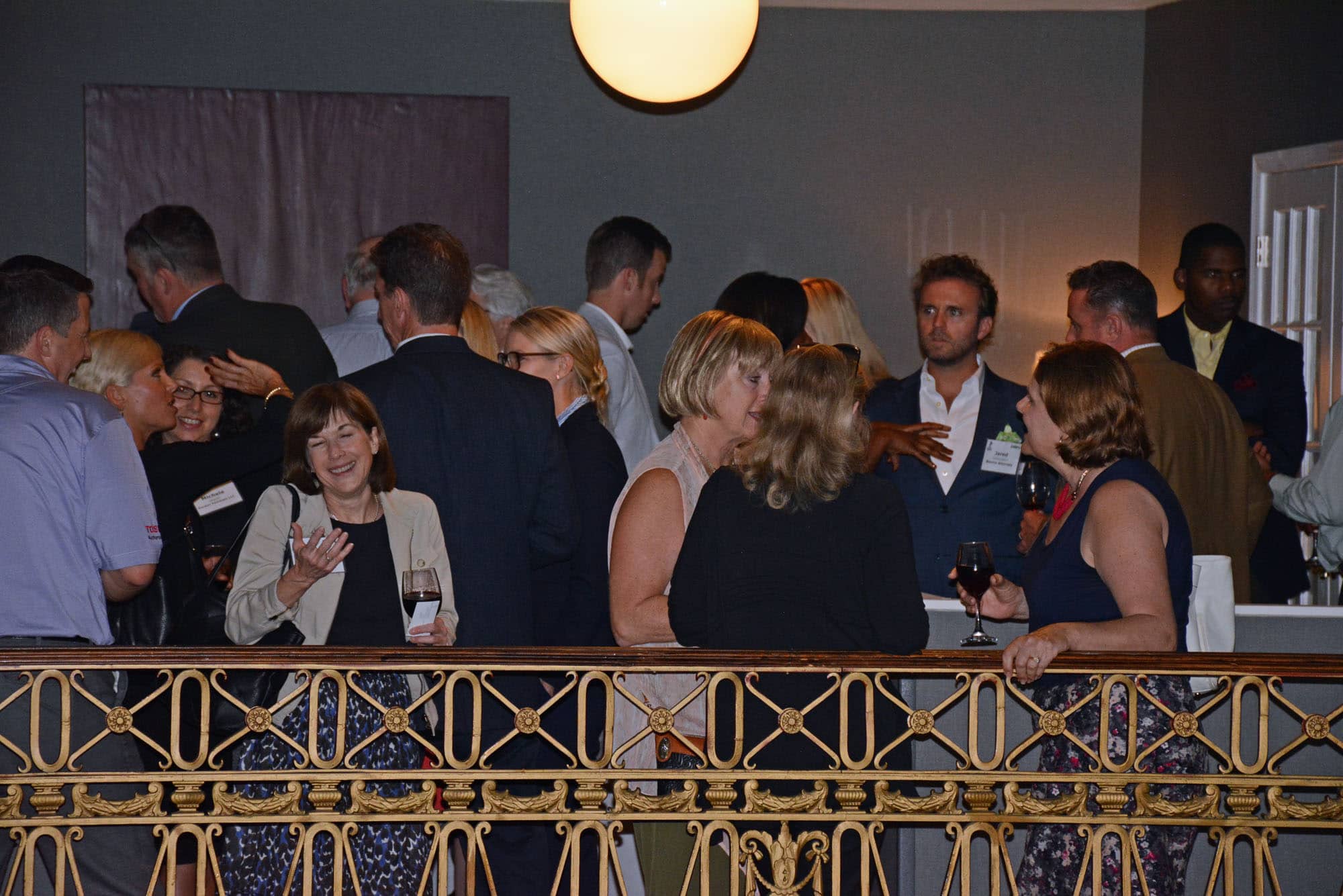Folks gathered at the mezzanine bar to network before the evening's guest speaker took the podium.