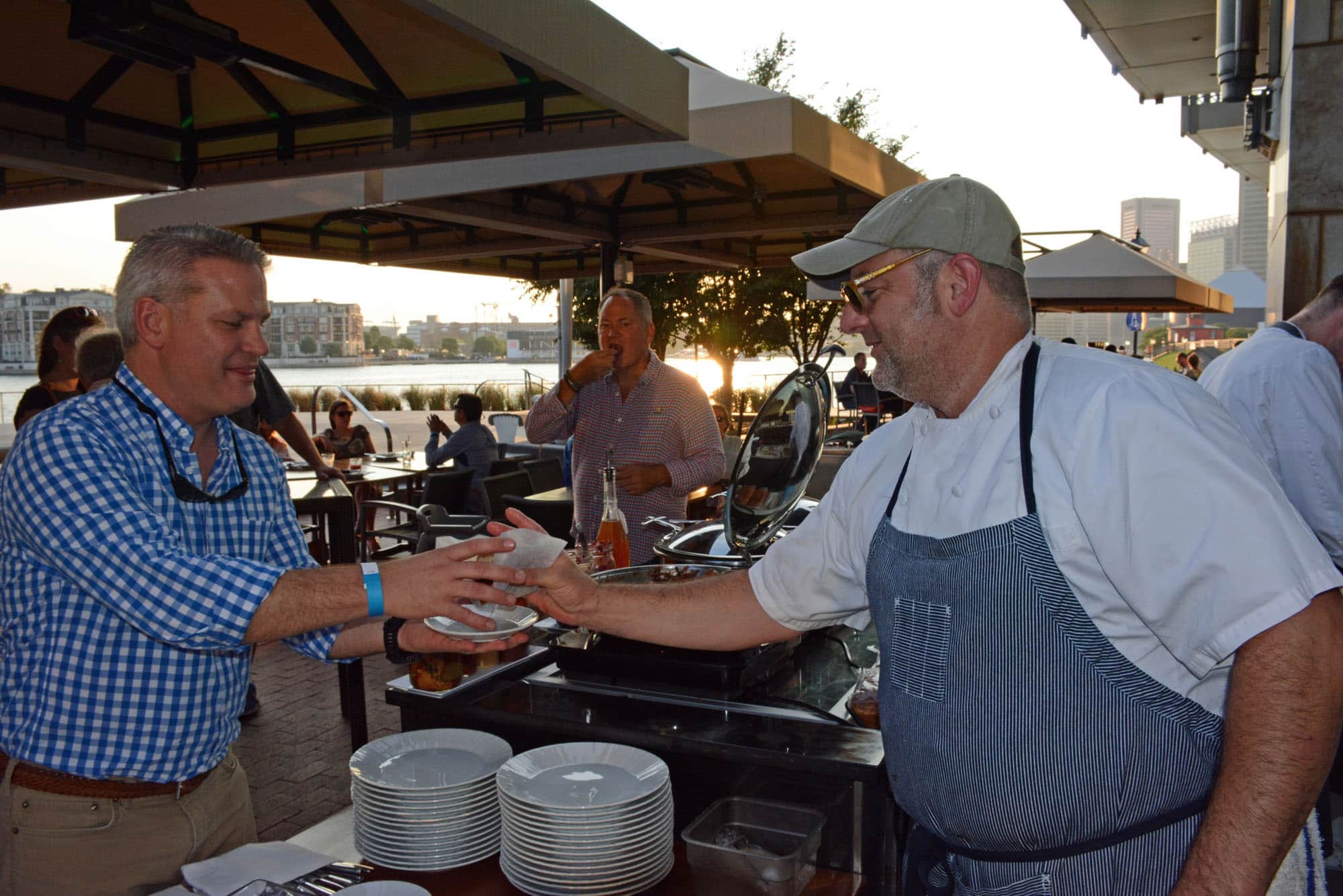 Chef Jerry Pellegrino serves up barbecue to one of the many hungry guests.