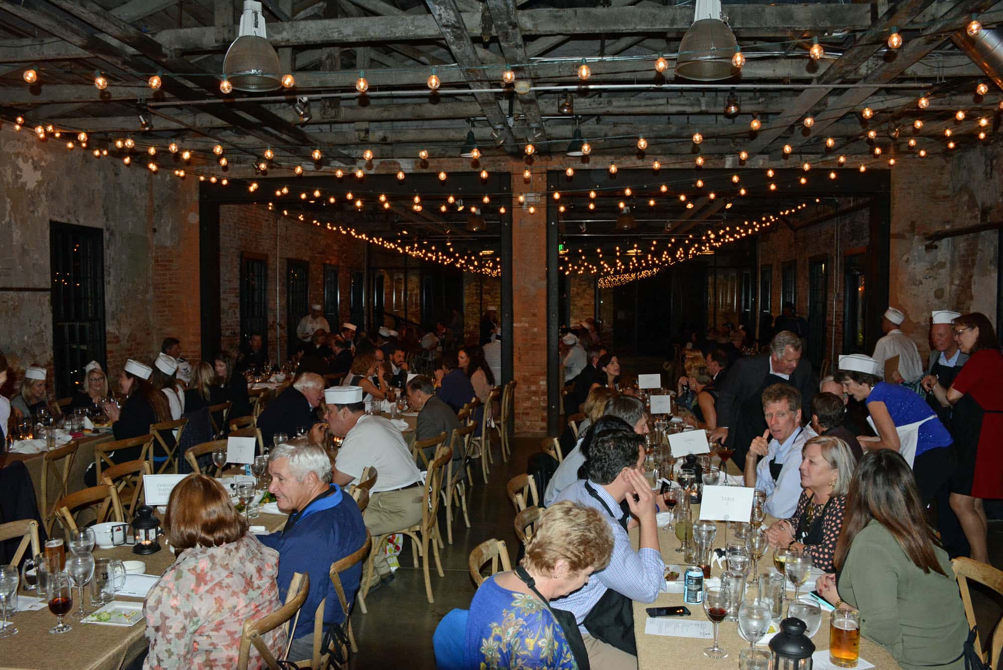 What’s Old Is New Again (October 13, 2016) Family and Children’s Services threw an updated version of a Beefsteak – a mid-19th century social gathering for men where they tore into mounds of meat and barrels of ale. Needless to say, this version was most definitely non-gender specific, though several of the old rules applied – no eating utensils or napkins. So folks were outfitted with aprons…though we’re not sure why the hats.
