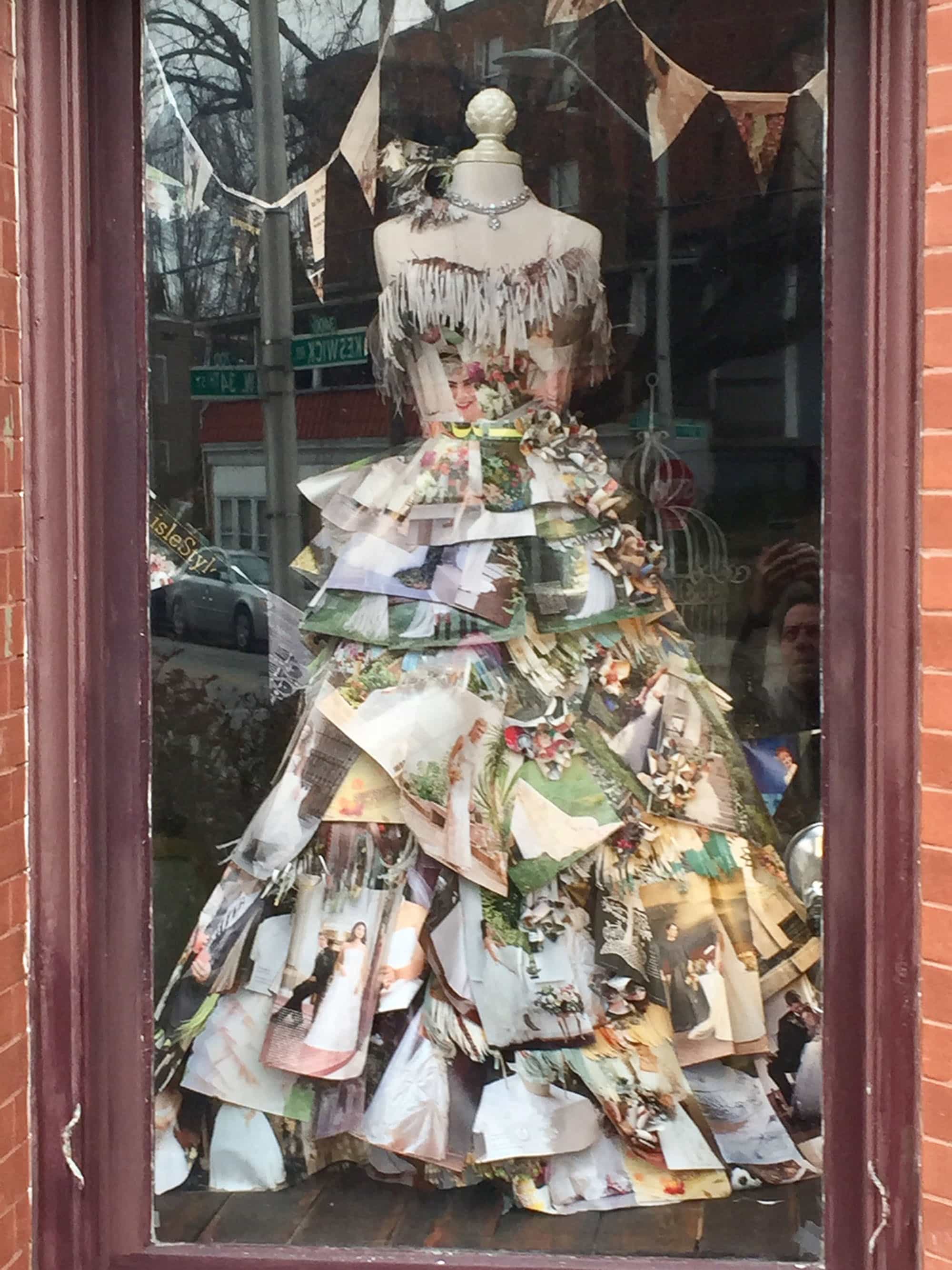 Talented local dress designer Jill Andrews maintains her salon in the beautifully restored old Northern District Police Station on Keswick Road in Hampden. On my morning running route one day earlier this week, I ran past the display window and was stopped by this stunner. It’s a gown made from magazine pages that she created for the current issue of Baltimore Bride magazine. That’s about the most stylish, creative dressmaking I can think of since Scarlett O’Hara made hers out of the house draperies!