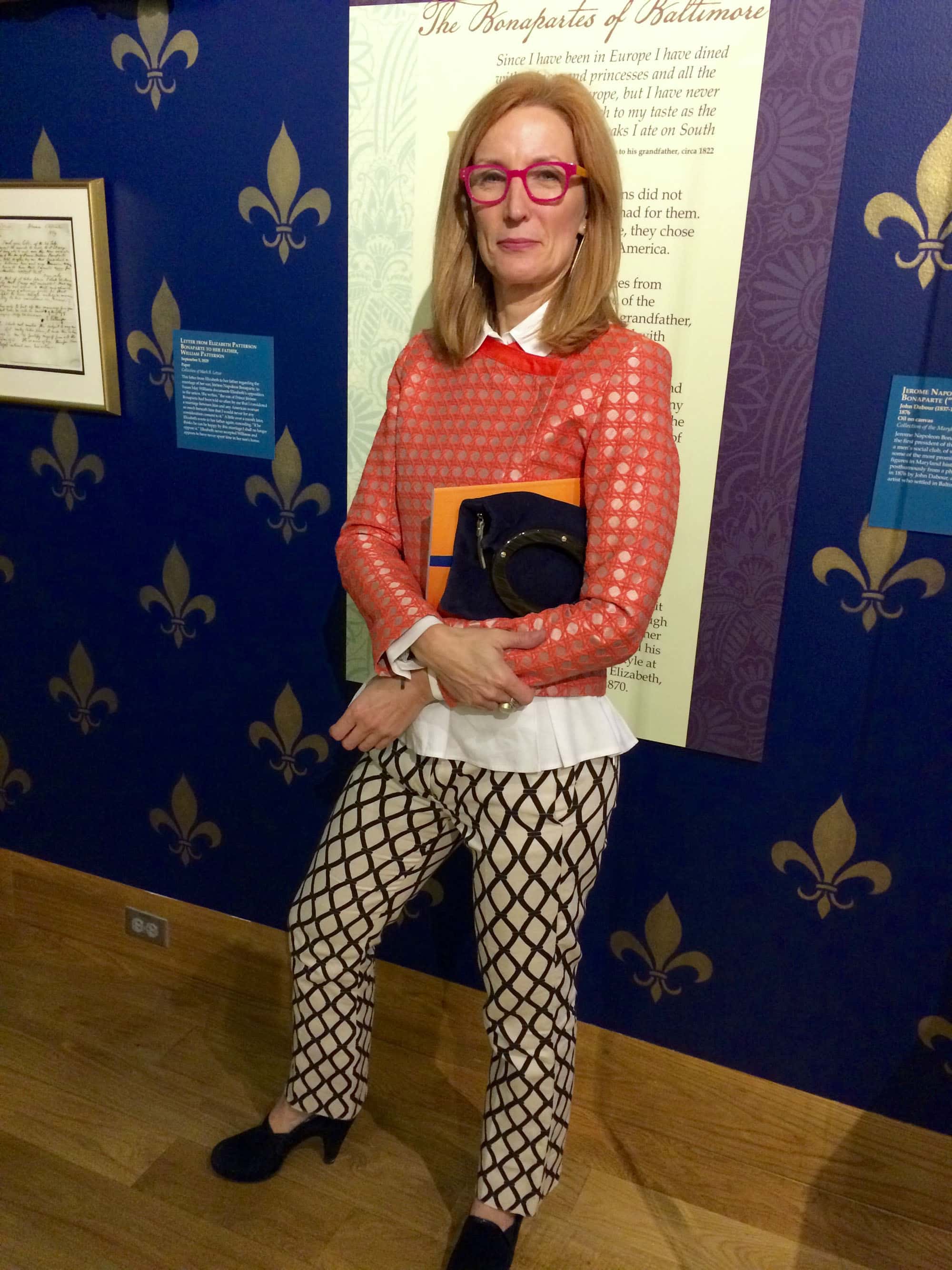 Rebecca Myers, jewelry designer -who's about to open jewelry shop in Cross Keys - sporting an orange top by POL from Wrabyn in West Annapolis, pants by Max Mara from New York, and shoes by Stuart Weitzman