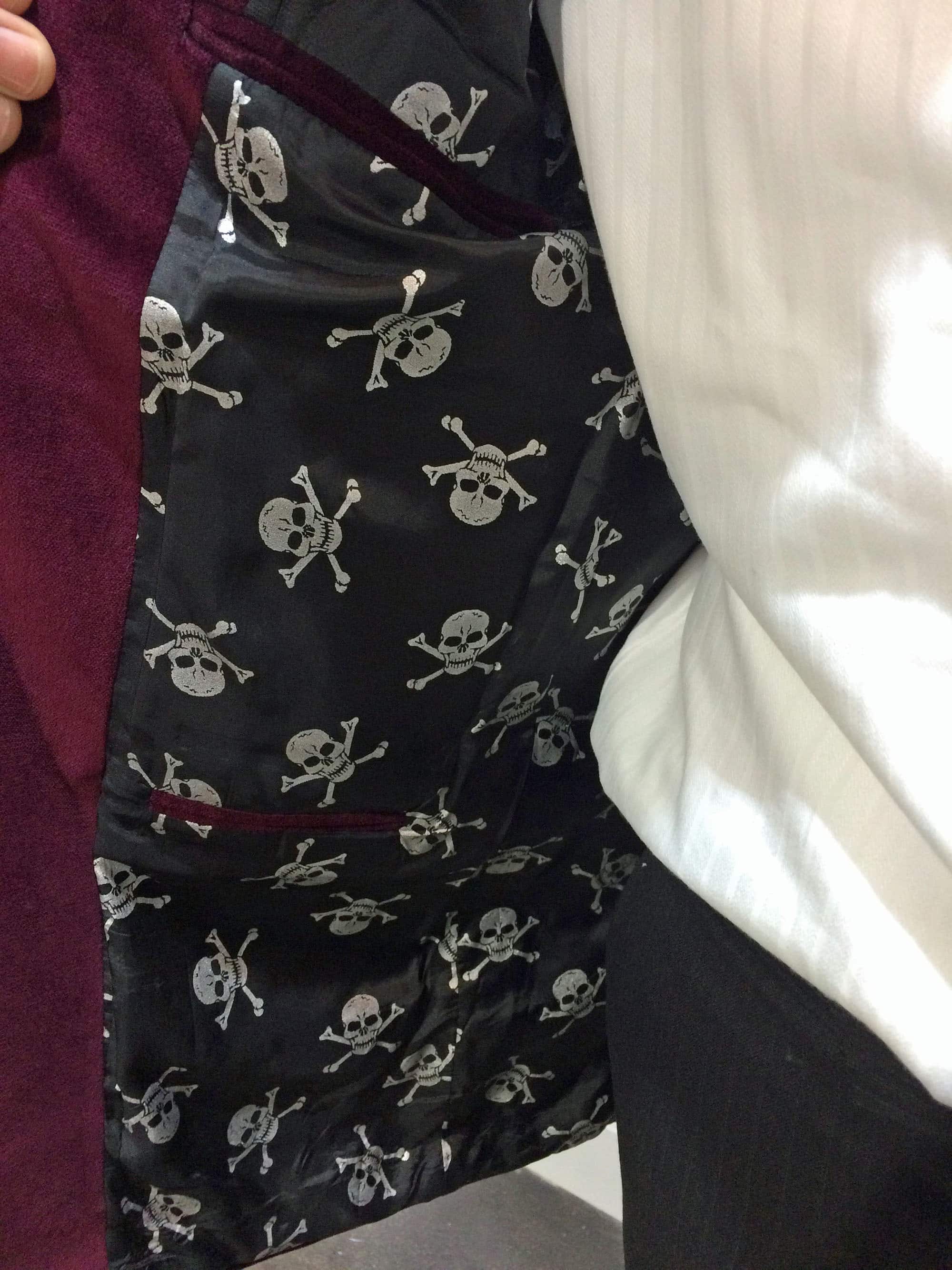 ...a black lining with little white skulls and crossbones designed by Steve Adelsberg.