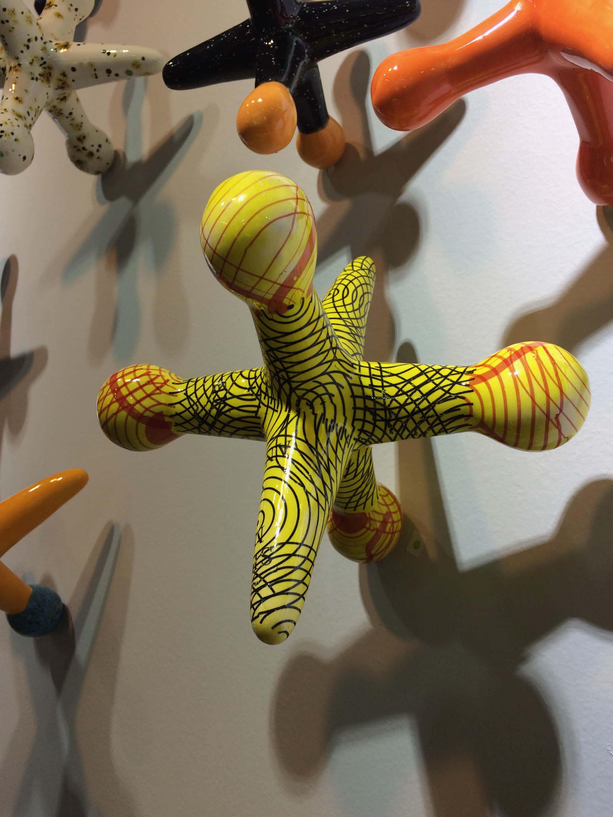 A wall covered in colorful jacks by Michigan artist Kaiser Suidan...